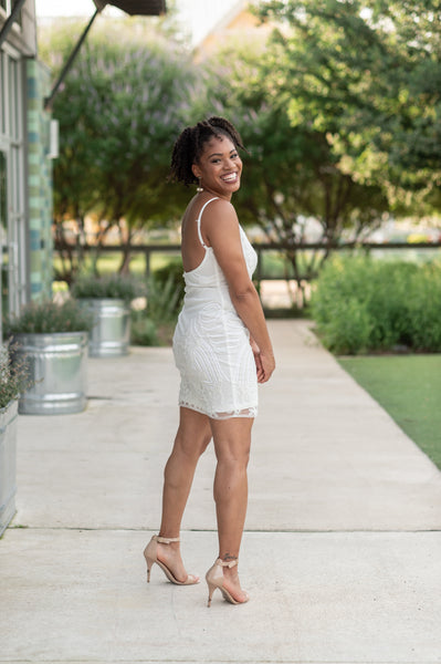 White dress shop with gold heels